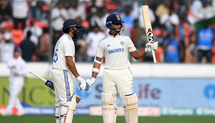 Indias Yashasvi Jaiswal (R) celebrates after scoring a half-century (50 runs) during the first day of the first Test cricket match between India and England at the Rajiv Gandhi International Stadium in Hyderabad on January 25, 2024. — AFP