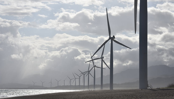 A representational image of a power-generating wind turbines. — Pexels