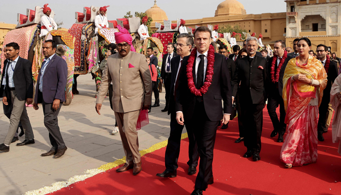 French President Emmanuel Macron (C), escorted by French ambassador to India, Thierry Mathou (C-L) attends a welcoming ceremony at Amber Fort in Jaipur on January 25, 2024. — AFP