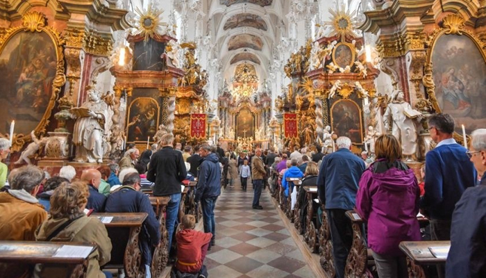 Visitors attend the inaugural pilgrimage high mass at the abbey church during the foundation of a new priory, the Kloster Neuzelle monastery in Neuzelle, eastern Germany. — AFP/File