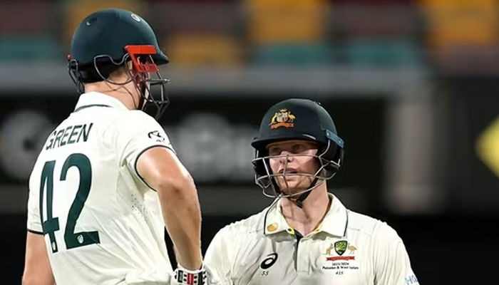 Steve Smith of Australia (R) and teammate Cameron Green confer on day three of the second cricket Test match between Australia and the West Indies at the Gabba in Brisbane. — AFP/File