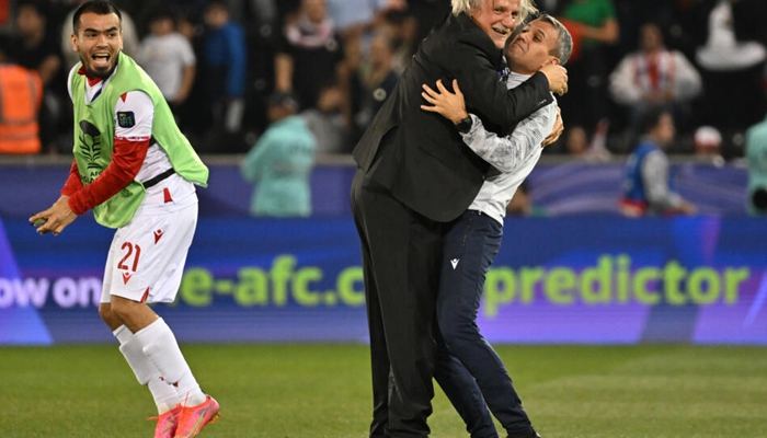 Tajikistan coach Petar Segrt celebrates with his team after beating Lebanon at the Asian Cup on January 27, 2024. — AFP
