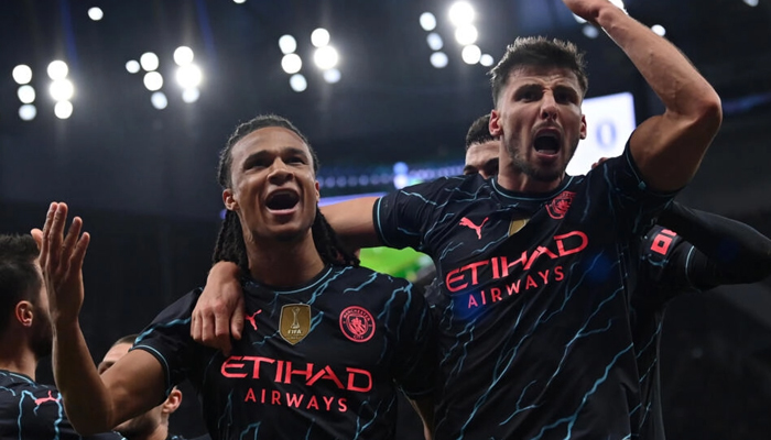 Manchester City defender Nathan Ake (L) celebrates his winner at Tottenham. — AFP
