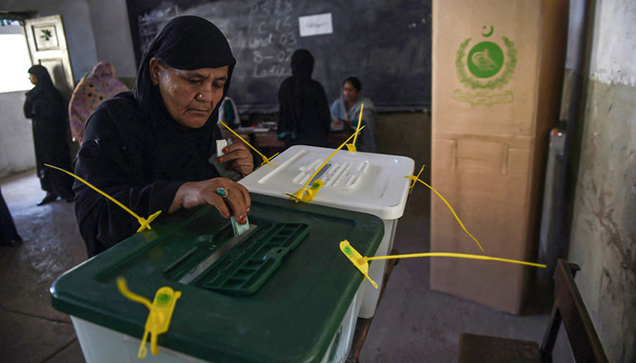 A Pakistani woman casts her ballot at a polling station in Karachi, during local government elections. — AFP/File
