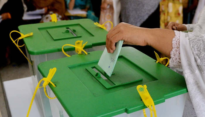 A woman can be seen casting her vote. — AFP/File
