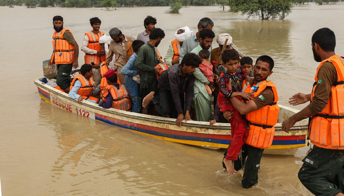 Rescue workers help evacuate flood-affected people from their flood-hit homes following heavy monsoon rains in Rajanpur district of Punjab province, Pakistan, Aug. 27, 2022. — AFP