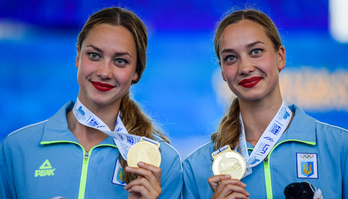 Gold medallists Ukraine´s Maryna Aleksiiva and Vladyslava Aleksiiva pose after competing in the Women´s Artistic Swimming duet free final event at the LEN European Aquatics Championships in Rome. — AFP/File