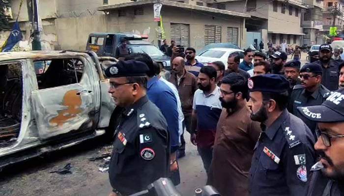 Police officials visit a site after a clash between two political party group activists during an election campaign rally at Nazimabad, Karachi on Monday, January 29, 2024.