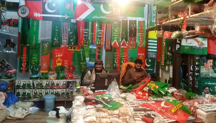 Shopkeepers await customers at their shop selling flags and other paraphernalia of political parties ahead of the general elections in Pakistan. — Photo by author