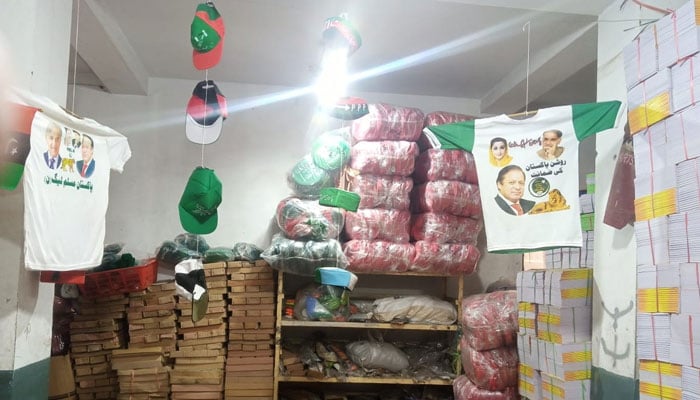 A warehouse displays caps and shirts bearing images of political leaders being sold ahead of general elections in Pakistan. — Photo by author