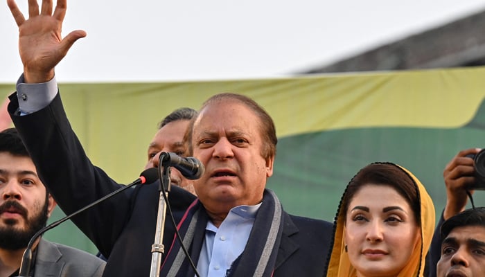 Pakistans former Prime Minister and leader of the Pakistan Muslim League (PML) party Nawaz Sharif (C) along with his daughter Maryam Nawaz (R) waves to supporters during an election campaign rally in Lahore on January 29, 2024. — AFP