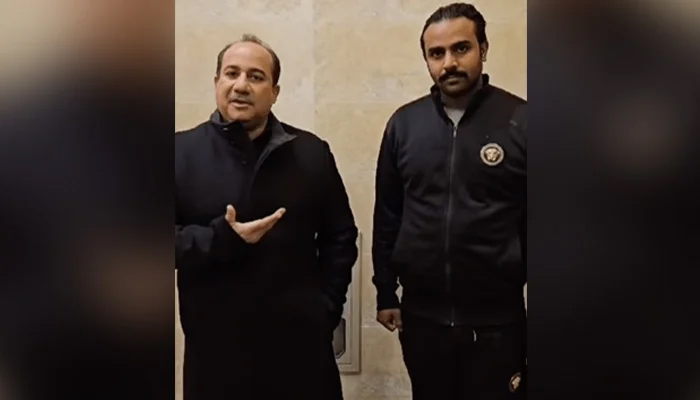 Rahat Fateh Ali Khan (left) with his student, Naveed Hasnain, in this still taken from a video. — Instagram/@officialrfakworld