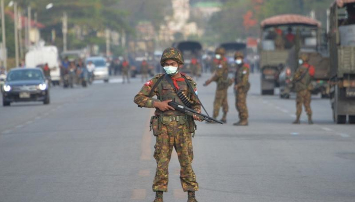 A Myanmar soldier stands guard on a road amid demonstrations against the military coup in Naypyidaw. — AFP/File
