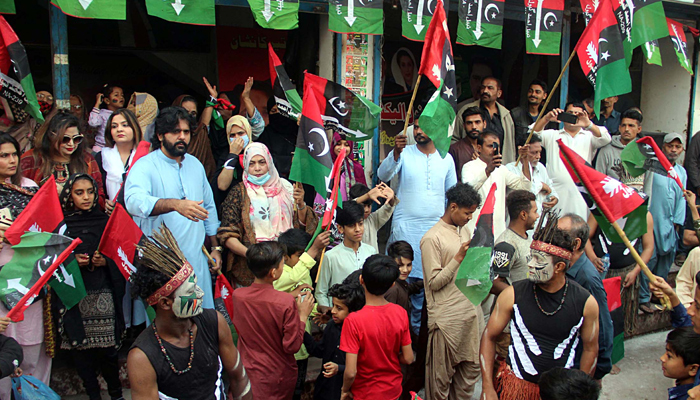 Activists of Pakistan Peoples Party performing a traditional dance before arriving PPP leader Asifa Bhutto Zardari during an election campaign rally at Liyari area in the Provincial Capital. — Online/File