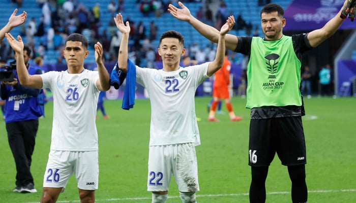Uzbekistans players celebrate with their fans after the Qatar 2023 AFC Asian Cup football match between Uzbekistan and Thailand at Al-Janoub Stadium on January 30, 2024. — AFP