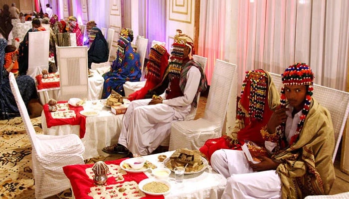 Brides and grooms from the Hindu community sit together during a mass marriage ceremony held in Rawalpindi. — APP/File