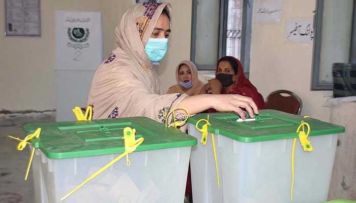 A woman casts her vote at a polling station on April 10, 2021. — APP