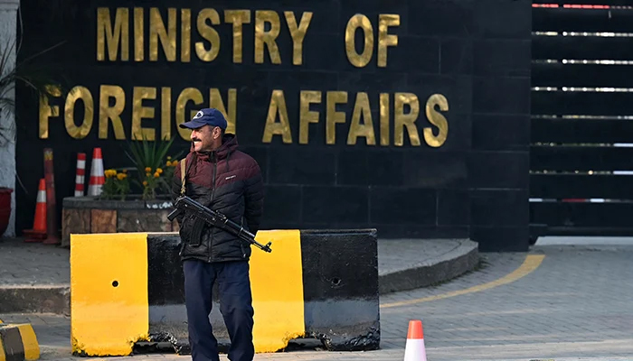 A Pakistani police officer checks a vehicle stand entering the Ministry of Foreign Affairs in Islamabad on January 18, 2024. — AFP