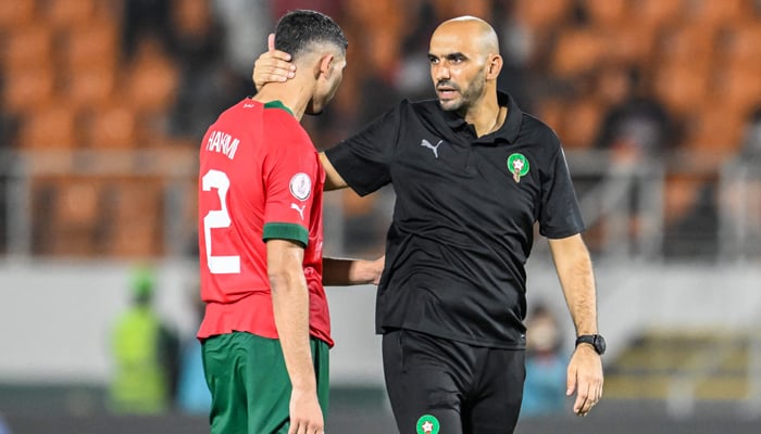 Morocco´s coach Walid Regragui (R) and Morocco´s defender #2 Achraf Hakimi (L) react after their loss in the Africa Cup of Nations (CAN) 2024 round of 16 football match between Morocco and South Africa at the Stade Laurent Pokou in San Pedro on January 30, 2024. — AFP