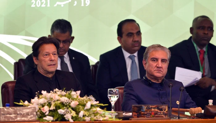 The then-Prime Minister Imran Khan and Foreign Minister Shah Mahmood Qureshi (R) attending the opening of a special meeting of the 57-member OIC in Islamabad on December 19, 2021. — AFP