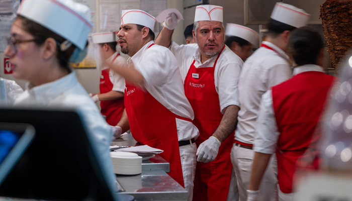 People work at a restaurant at Chelsea Market in Manhattan on February 02, 2024, in New York City. — AFP