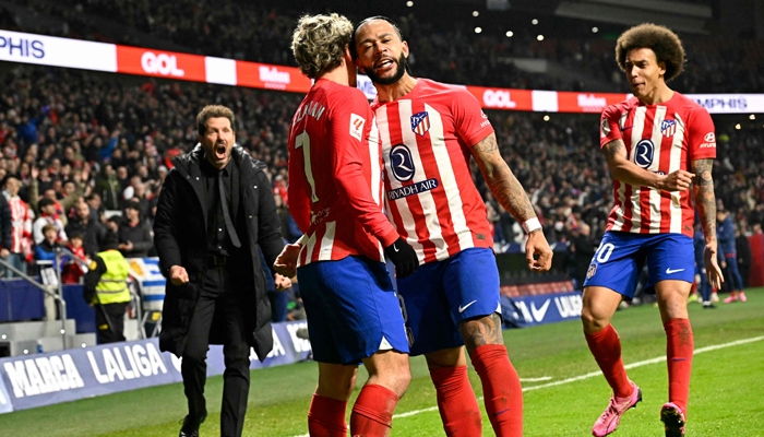 Atletico Madrids Memphis Depay (2R) celebrates scoring his teams second goal during the Spanish league football match between Club Atletico de Madrid and Rayo Vallecano de Madrid at the Metropolitano stadium in Madrid on January 31, 2024. — AFP