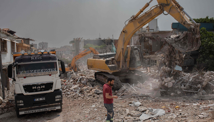 Workers remove debris from destroyed buildings in Hatay on May 22, 2023, one of the cities worst affected by the devastating earthquakes in southern Turkey earlier in the year. — AFP