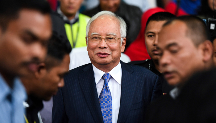 Malaysias former prime minister Najib Razak (C) leaves a court in Kuala Lumpur on April 3, 2019, after facing his trial over alleged involvement in the looting of sovereign wealth fund 1MDB. — AFP