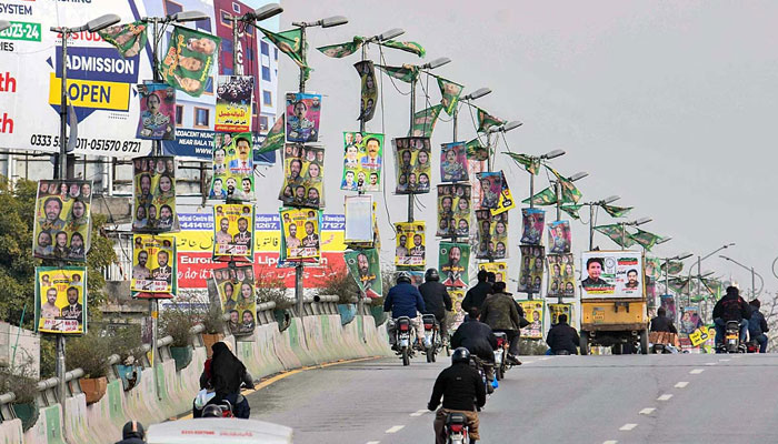 The image released on Feb 1, 2024 shows a view of banners of candidates on the street lights at 6th Road in Rawalpindi in connection with upcoming General Elections-2024. — APP File