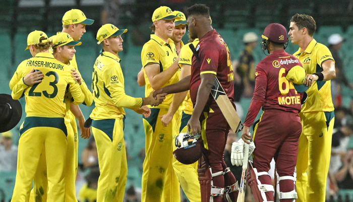 Australian players celebrate their victory in the second one-day international (ODI) cricket match against West Indies at the Sydney Cricket Ground on February 4, 2024. — AFP