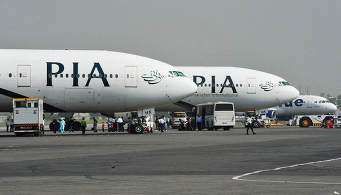 Pakistan International Airline (PIA) planes are positioned on the tarmac at an airport in Islamabad. — AFP/File