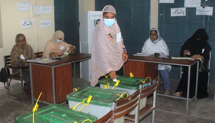 A woman casting her vote at a polling station during a by-election in Multan on October 6, 2022. — APP