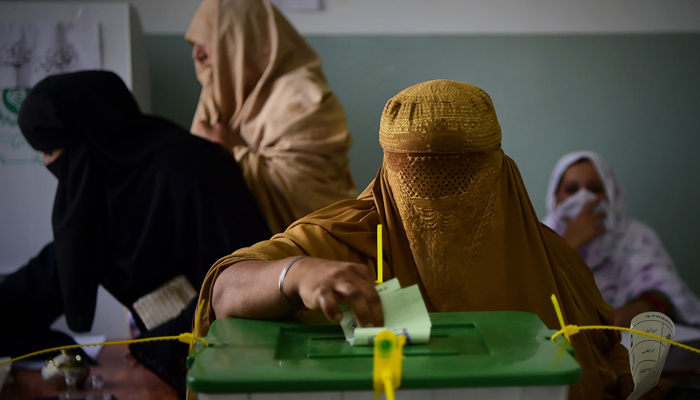 A woman casts her vote during Pakistans general election in Peshawar. — AFP/File