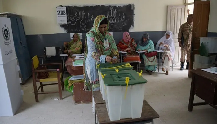 An election official seals ballot boxes before people vote during the general election at a polling station in Islamabad. — AFP/File