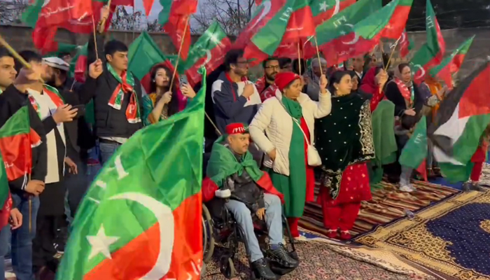 Pakistan Tehreek-e-Insaf (PTI) activists in London listen to a virtual gathering of their party in this still on December 17, 2023. — X/@PTI_London
