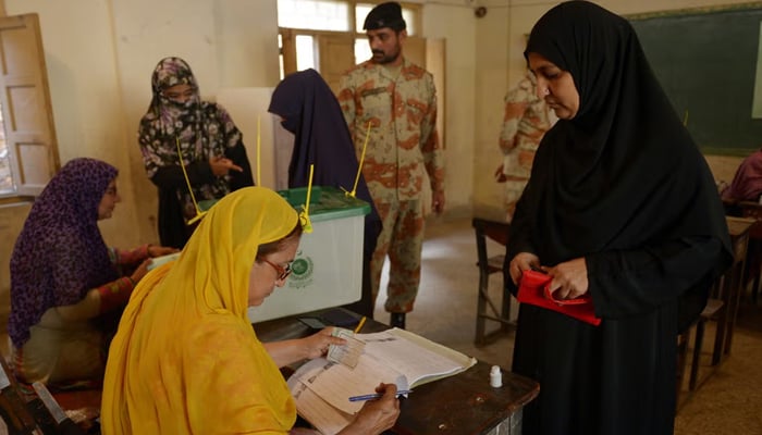 A voter casting her vote at a Karachi polling station. — AFP/File