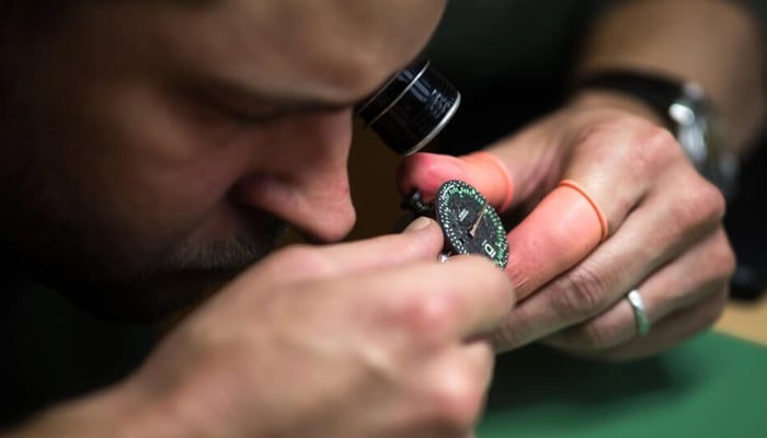 D Geneve brand co-founder Cedric Mulhauser works on a watch movement