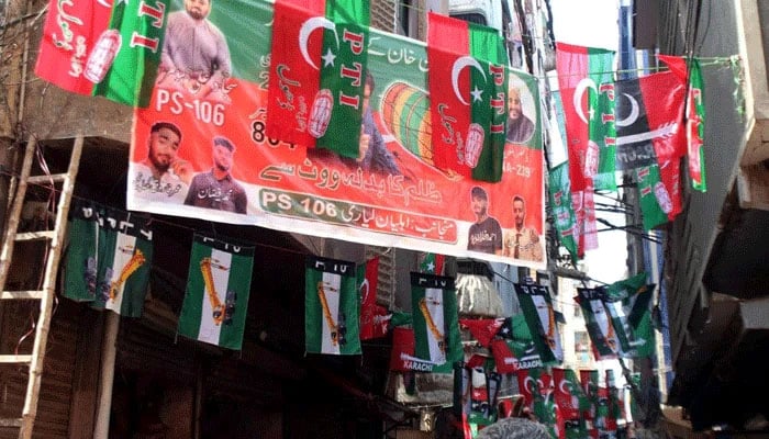 Banners and flags of different political parties have been placed in connection with the upcoming General Election 2024, at the Lyari area in Karachi on Wednesday, January 31, 2024. — PPI