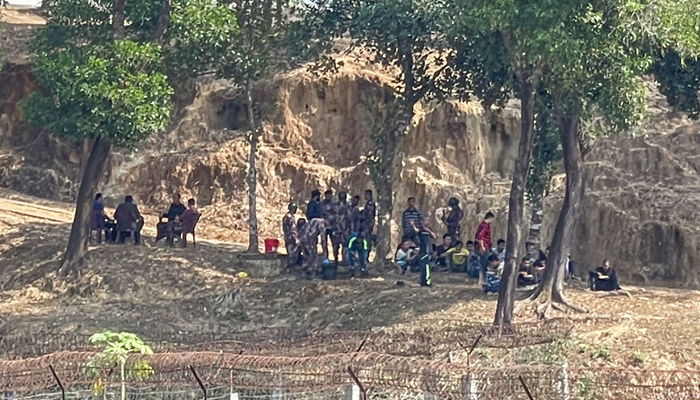Myanmars Border Guard Police personnel speak with Border Guard Bangladesh personnel after seeking refuge at Bangladeshs Ghumdum border in Bandarban district on February 5, 2024. — AFP