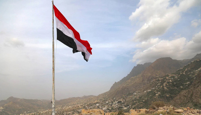 A Yemeni flag waves in the city of Taez. — AFP