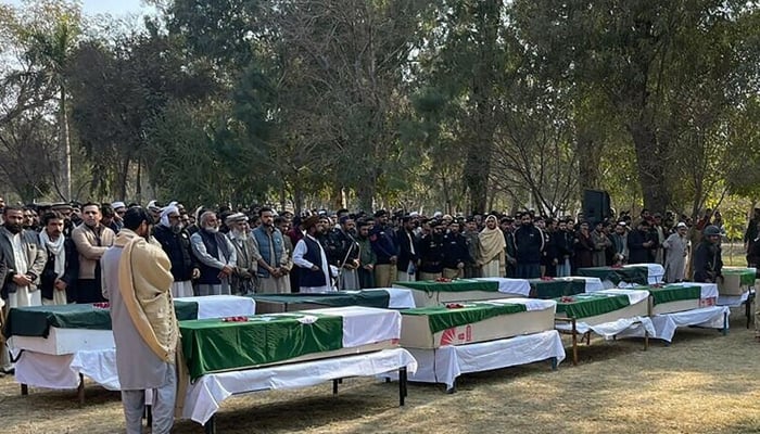 Security officials prepare to offer prayers for slained police officers during a funeral following an assault on a police station in Dera Ismail Khan on February 5, 2024. — AFP