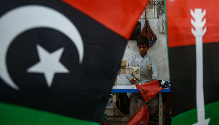 A worker stitches flags of PPP at a factory in Karachi, ahead of the upcoming general elections  on January 15, 2024. — AFP