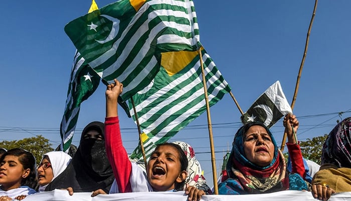 Protesters hold Kashmiri flags Kashmir Solidarity Day in Karachi. — AFP/File