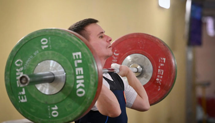 Russian weightlifter Oleg Masukhranov can be seen lifting weights. — AFP/File
