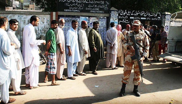 Rangers soldier standing alert at a polling station during local government elections in Karachi. — Online/File