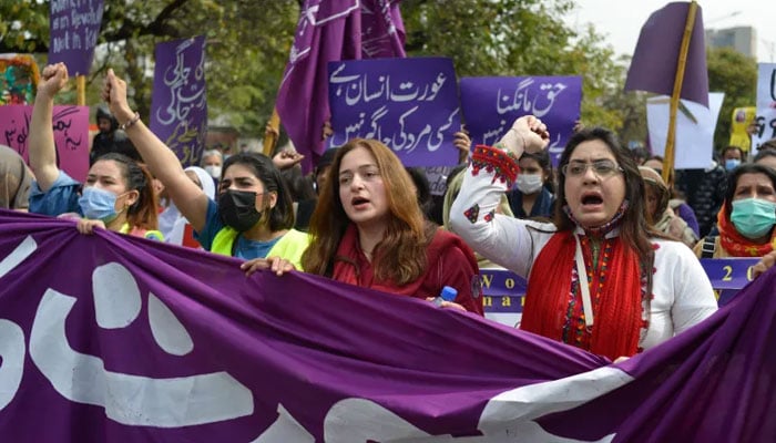 Aurat March protesters hold placards as they gather to mark International Womens Day in Islamabad. — AFP/File