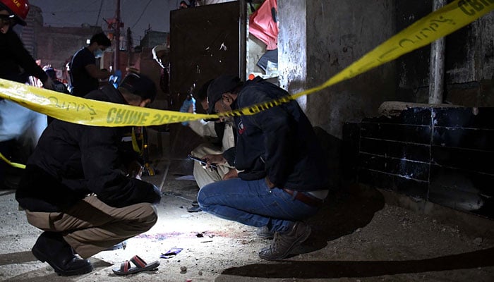 Security officials examine the site of a bomb blast in Karachi on February 7, 2024. — Online