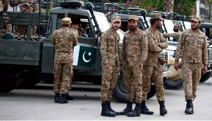 Security personnel convoy stand alert to avoid untoward incidents during the election materials distribution process in connection with the General Election 2024 coming ahead, at the Election Commission Distribution Center in Karachi on February 7, 2024. — PPI