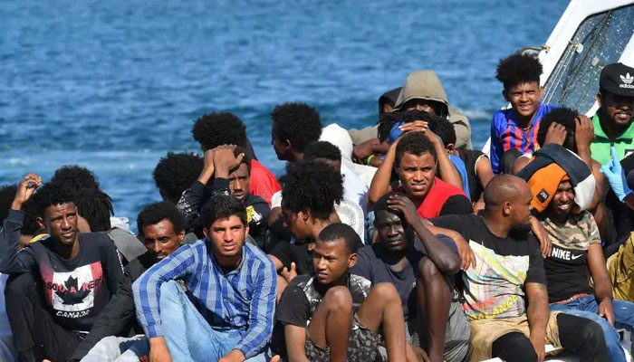 Migrants from Tunisia and Lybia arrive onboard an Italian Guardia Costiera (Coast Guard) boat on the Italian Pelagie Island of Lampedusa on August 1, 2020. — AFP
