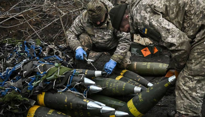 Ukrainian servicemen prepare to fire towards Russian positions with a 155 mm M777 Howitzer artillery weapon on the front line somewhere near the city of Bakhmut on March 11, 2023. — AFP
